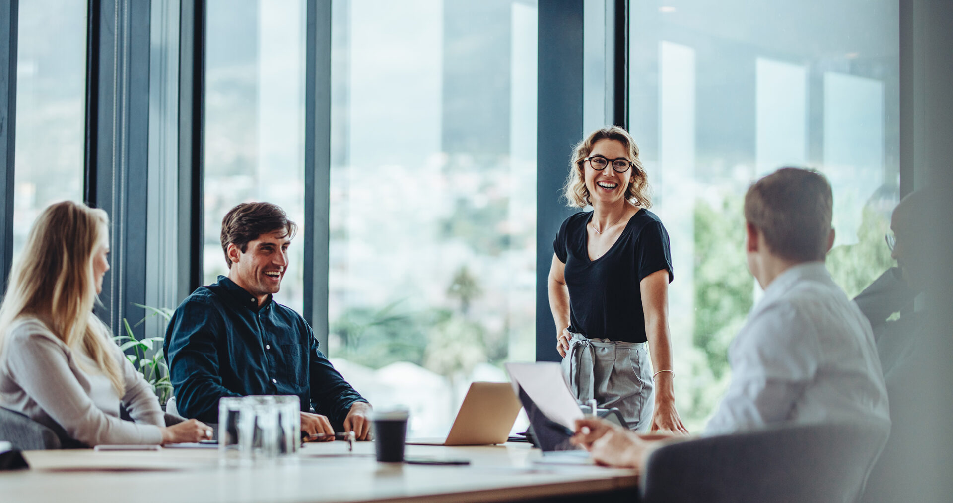 Smiling team in a modern office meeting.