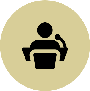 Person icon at podium with microphone.