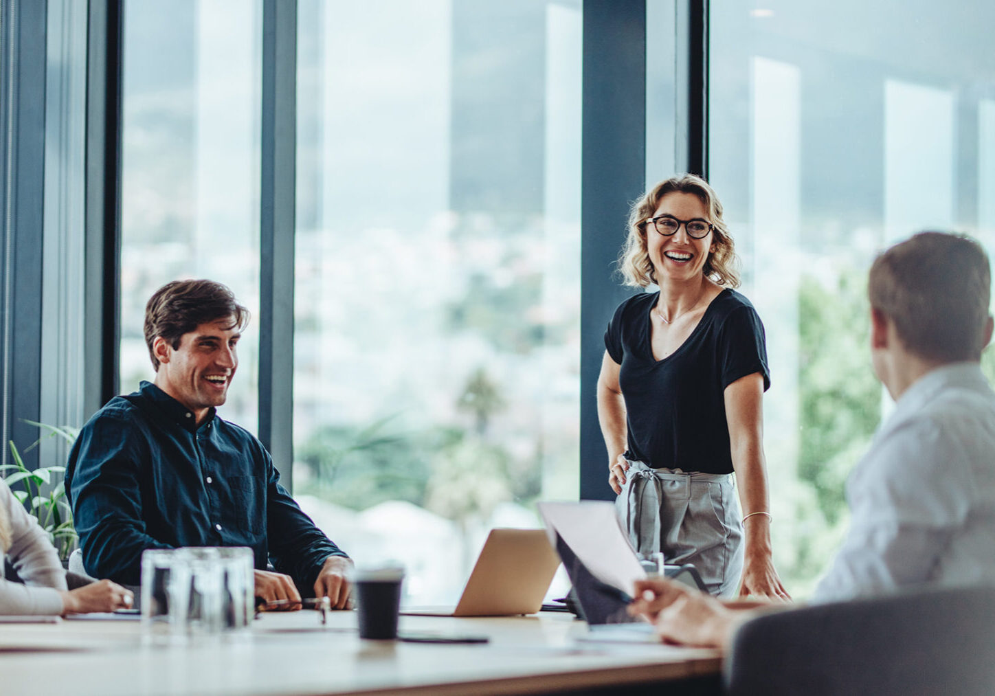 Smiling team in a modern office meeting.